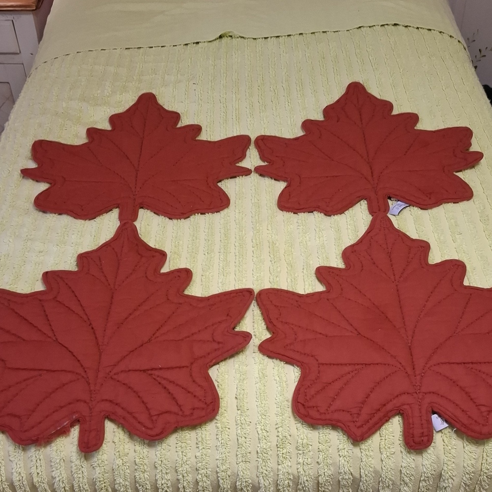 Leaf placemats, set of (4) in rust. Polyester with cotton fill. 15 1/2" X 16".